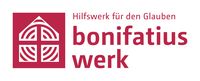 Schriftzug in Rot, ein Haus und ein Kreuz sind zu sehen